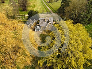 aerial view of a country estate with a large tree and grassy field