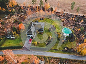 Aerial view of a country house in the woods, the trees and the road. Photo taken from a drone. Finland, Pornainen