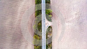 Aerial view of a country road amid fields spring.