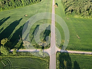 Aerial view of a country road crossroads in summer evening