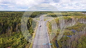 Aerial view of a country road with an intersection and a small number of cars.