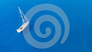 aerial view of couple enjoying sunbathing on the luxury yacht moving in the sea. Travel vacation.