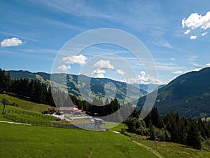 Aerial view on cozy hut with mountain panorama from Hinterglemm to Saalbach in the Alps in Austria. on a sunny summer