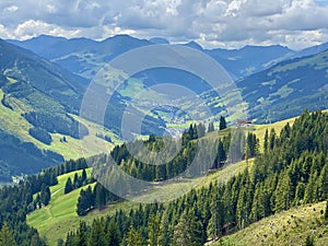 Aerial view on cozy hut with mountain panorama from Saalbach to Hinterglemm in the Alps in Austria on a sunny summer day photo