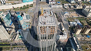 Aerial view of a crane over the skyscraper building  -construction in an urban city