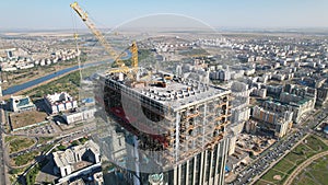 Aerial view of a crane over the skyscraper building  -construction in an urban city