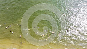 Aerial view crowd kids and adults swimming and floating at City Beach Park in Granbury, Texas