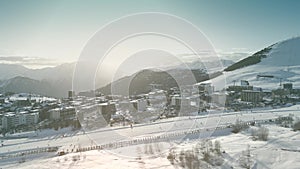 Aerial shot of hotels and an Alpine ski track in famous Alpe d'Huez ski resort, France photo