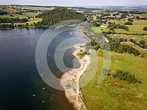 Aerial view of a crowded beach on the shore of a large lake in summer (Ullswater, Lake District, England