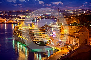 Aerial view of cruise ship in Grand Harbour in night, Valletta,