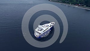 Aerial view of cruise yacht on water. Vacation party on ship. Boat on river