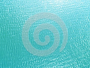 Aerial view of a Crystal clear sea water texture. View from above Natural blue background. Turquoise ripple water reflection in tr
