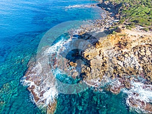 Aerial view of crystal clear water by Porto Ferro shore
