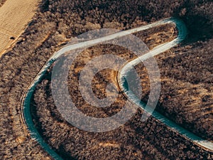 Aerial view of curve asphalt road serpentine in spring mountains, top view