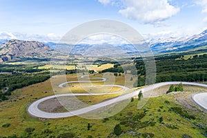 Aerial view of the curved asphalt road trough mountains. Carretera Austral road near the Cerro Castillo National Park. Chile