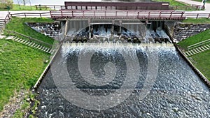 aerial view on dam lock sluice on river impetuous waterfall.