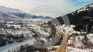 Aerial view of dark forest, snow-covered land and fog clouds, Odemis izmir Turkey.