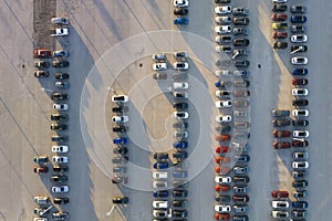 Aerial view of dealership parking lot with many brand new cars for sale. Development of american automotive industry