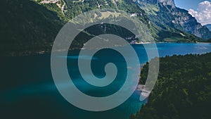 Aerial view of deep blue mountain lake in swiss alps, klontalersee switzerland