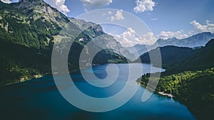 Aerial view of deep blue mountain lake in swiss alps, klontalersee switzerland