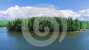 Aerial view of Deep Creek Lake in Maryland, USA, with a small island in the center with pine trees