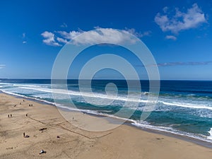 Aerial view on difficult to access golden sandy Cofete beach hidden behind mountain range on Fuerteventura, Canary islands, Spain