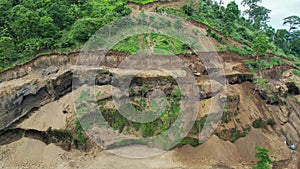 Aerial view of digger cleaning destruction of a jungle landslip