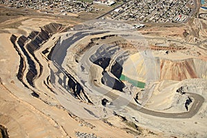 An aerial view of the dikes and terraces at an open pit copper mine.