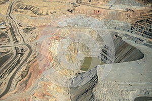 An aerial view of the dikes and terraces at an open pit copper mine.