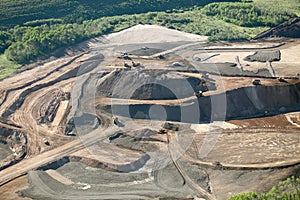 An aerial view of the dikes and terraces at an open pit phosphate mine. photo