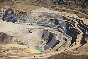 An aerial view of the dikes and terraces at an open pit copper mine. photo