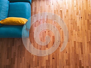 Aerial view of a dining room, brown parquet and green sofa