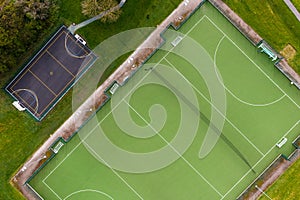 Aerial view directly above an outdoor hockey pitch and basketball court