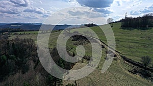 Letecký pohled na polní cestu na louky a pastviny kopce středního Slovenska během jarní sezóny