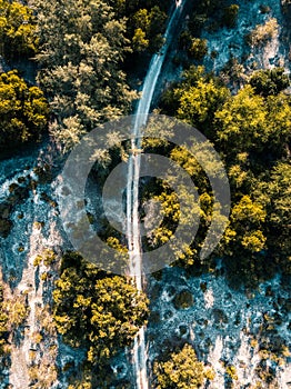 Aerial view of Dirt road in between of lake and sea at serangan beach bali,