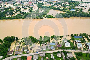 Aerial view of Dnister river with dirty water and  flooded houses in Halych town, western Ukraine photo