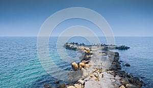 Aerial view of a dock with stabilopods rocks in the Black Sea during a cloudy day