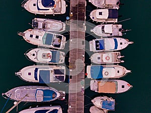 Aerial view of the docs with many yachts docked next to each other.