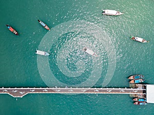 Aerial view of dolphin bridge with boats anchored at Chalong Pier