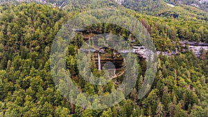 Aerial view of double water fall in a forest.