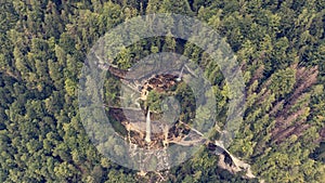 Aerial view of double water fall in a forest.