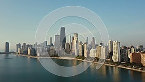 Aerial view of the downtown of Chicago, America and Michigan lake. Copter flying up to downtown on the dawn.