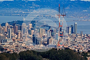 Aerial view of downtown San Francisco and Financial District skyline with Sutro tower in the foreground, flying over Twin Peaks