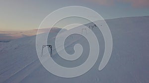 Aerial view of the drag lift on a snow-capped mountain, early morning
