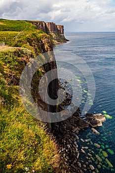 Aerial view of the dramatic coastline at Staffin Cliffs with the famous Kilt Rock Waterfall - Isle of Skye - Scotland.