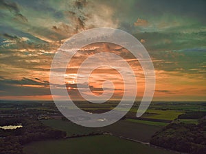 Aerial view of a dramatic sunset over open farmland in the English countryside