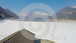 Aerial view of dried lake, empty dock, sunny day in beautiful mountains, glacier