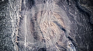 Aerial view on dried river Rio Grande basin on Nazca desert with Nazca lines in the middle, surrounded by mountains.