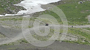 Aerial view of Driver Driving a Sports Atv on the Dirt Road. Atv Rides on Mountain Trail