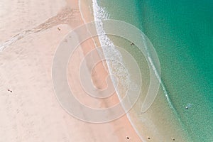 Aerial view with drone of a beach in wave of turquoise sea water shot, top view of beautiful white sand background. Holidays